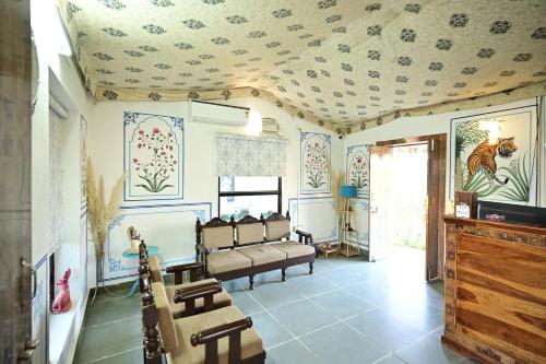 a living room with a couch and a ceiling at The castle crown - Hem Vilas Resort Ranthambhore in Sawāi Mādhopur