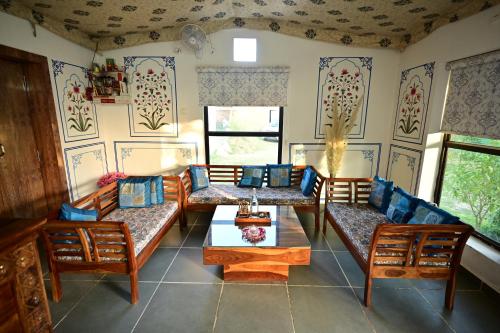 a living room with couches and a table at The castle crown - Hem Vilas Resort Ranthambhore in Sawāi Mādhopur