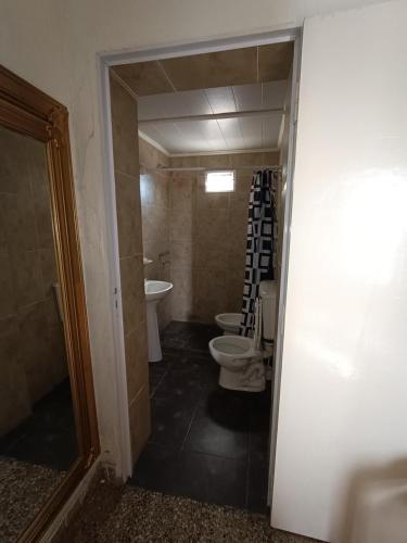 a bathroom with two toilets and a sink at La Casona de Dante in Ramallo