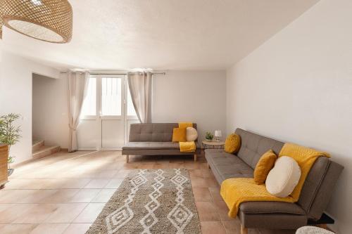 a living room with a couch and a chair at Moradia Marques in Nazaré