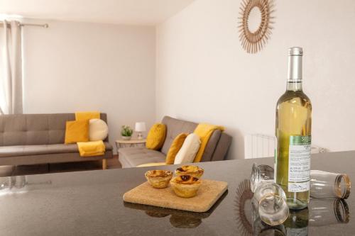 a bottle of wine sitting on a table in a living room at Moradia Marques in Nazaré