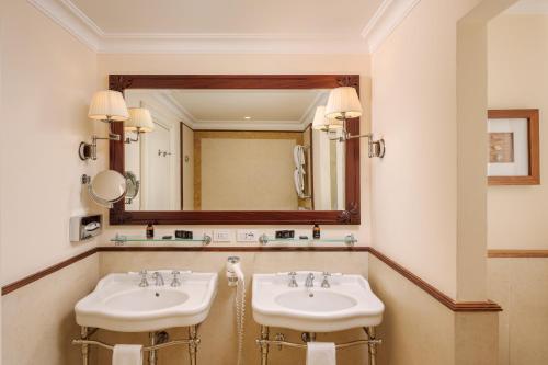 two sinks in a bathroom with a large mirror at Grand Hotel Bristol Spa Resort, by R Collection Hotels in Rapallo