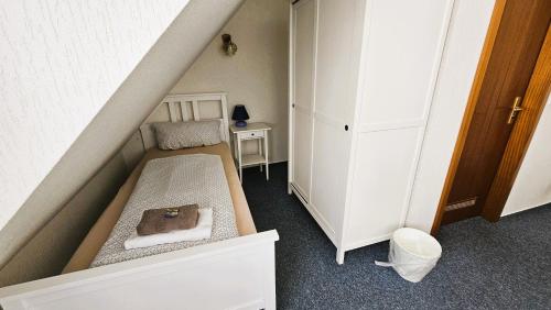 a small room with a bed and a small table at Hotel Dorfkrug Büsum in Büsum