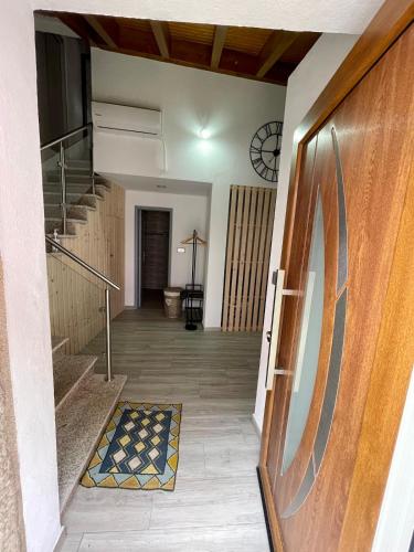a hallway with stairs and a door with a stair mat at Casa do Relógio in Tarouca