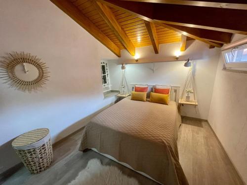 a bedroom with a bed and a mirror on the wall at Casa do Relógio in Tarouca