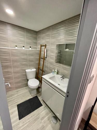 a bathroom with a toilet and a sink at Casa do Relógio in Tarouca