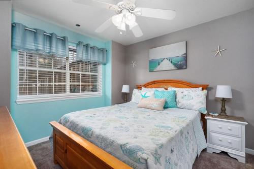 a bedroom with a bed and a ceiling fan at Lakeside Laziness 28-4 By SDC, Big Deck, Pool, Hot Tub, Pets Ok, Resort On Lake in Branson