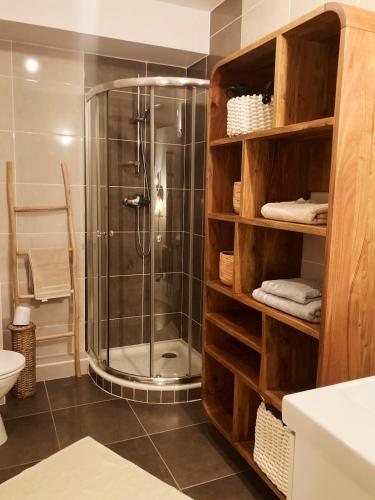 La salle de bains est pourvue d'une douche et d'une cabine de douche en verre. dans l'établissement 'L'Élégant' Studio Centre, Parking privé, Clim, Terrasse, à Sète