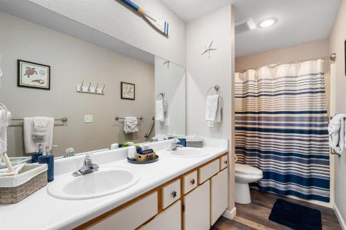 a bathroom with two sinks and a shower at Lakeside Laziness 28-4 By SDC, Big Deck, Pool, Hot Tub, Pets Ok, Resort On Lake in Branson