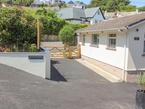 a white house with a gate and a driveway at Rock Point in Salcombe