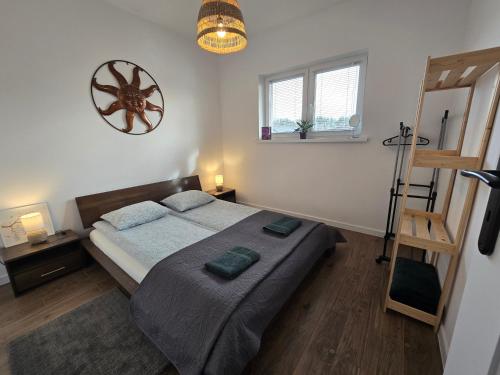 a bedroom with a bed and a wooden floor at Apartament Danuta Mrągowo in Mrągowo