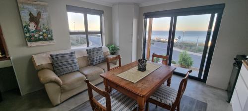 a living room with a couch and a table at MaKarLi Blu in St Helena Bay