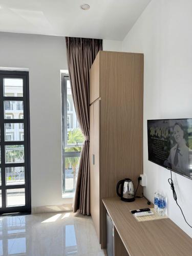 a living room with a cabinet and a window at Thu Trang DeLaSea Hà Tiên Motel in Ha Tien