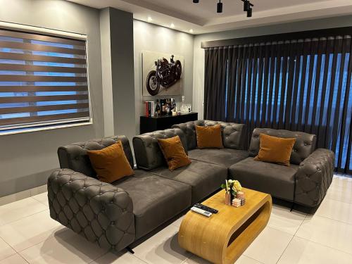 a living room with a couch and a table at Seaside Serenity Maisonette - Private Pool in St. Paul's Bay