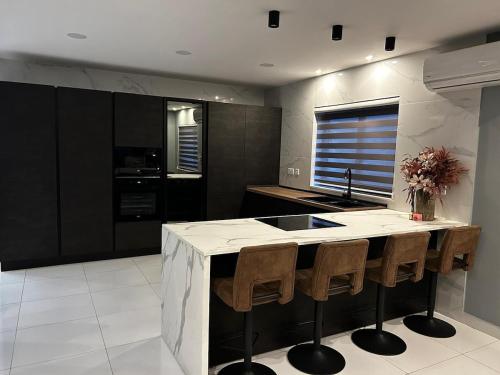 a kitchen with a large island in the middle at Seaside Serenity Maisonette - Private Pool in St. Paul's Bay