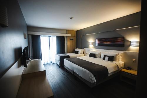 Ein Bett oder Betten in einem Zimmer der Unterkunft Mercure Camboriu
