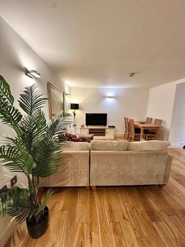 a living room with a couch and a table at Opulent oasis in London in London