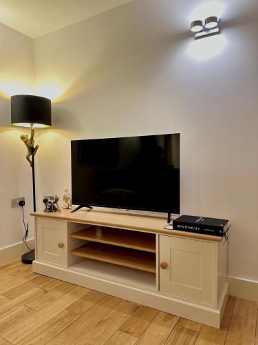 a living room with a large flat screen tv at Opulent oasis in London in London