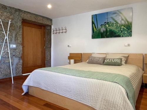 a bedroom with a large bed in a room at Casa da Aldeia in Vilela