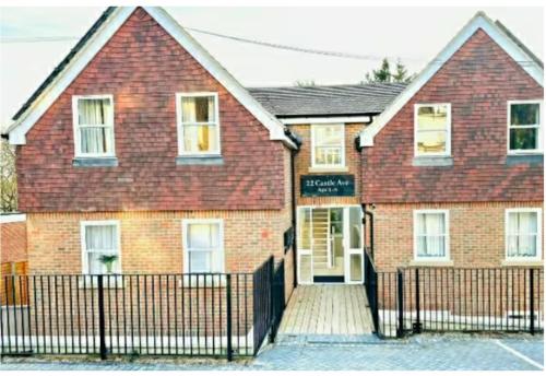 a brick house with a fence in front of it at Port of Dover Lodge 20 sleeps in Dover