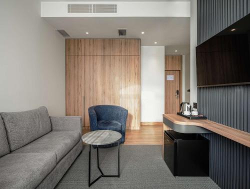 a living room with a couch and a table at Radisson Hotel & Spa Gyumri in Gyumri