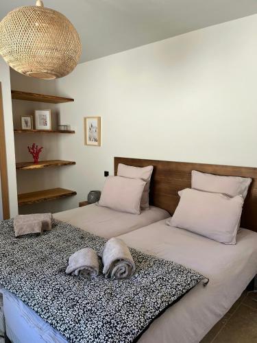 une chambre avec deux lits avec des oreillers dessus dans l'établissement Beautiful Stone House With Sea View In Corsica, à Sari-dʼOrcino