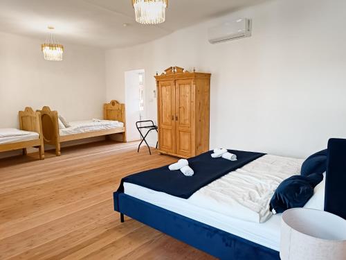 a bedroom with a large bed in a room at Anno 1859 Vendégház in Bátaszék