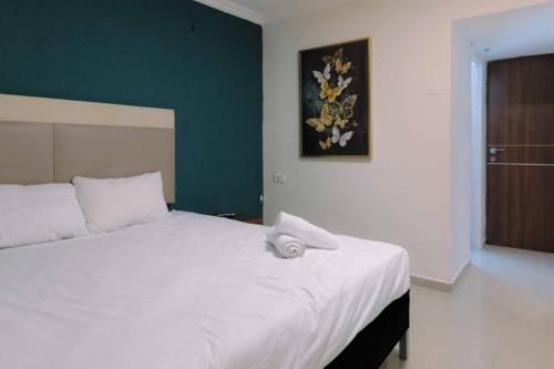 a bedroom with a large white bed in a room at Rich Boutique Hotel in Eilat