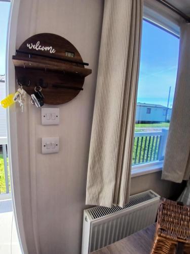 a suitcase is hanging on a wall next to a window at Serenity - Luxury Hot Tub, Sunnymede, Fantasy Island, , Ramped Access, Parking, Dog Friendly in Ingoldmells