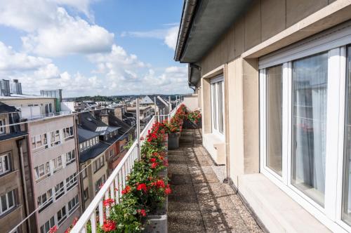 a balcony with flowers on a building at The Queen Luxury Apartments - Villa Carlotta in Luxembourg
