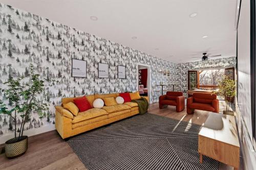 a living room with a yellow couch in front of a wall at Wildview Retreat in Lake Lure