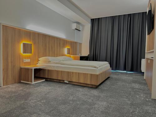 a bedroom with a large bed in a room at Apartment OneClickRenrt Oasis in Chişinău