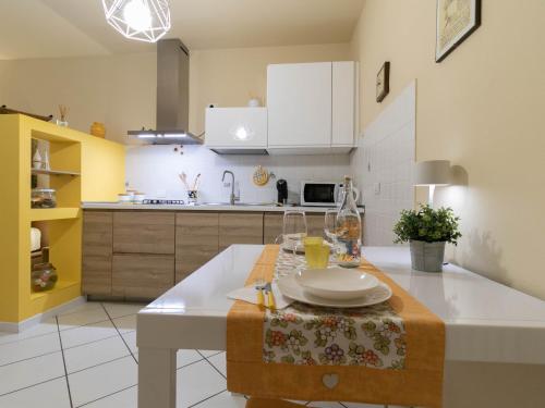 a kitchen with a table with plates and glasses on it at Casa Lisander in Lecco