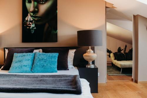 a bedroom with a bed with a painting on the wall at Loft Thaler Rooms in Bolzano
