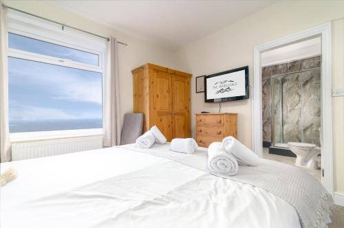 a bedroom with a large white bed and a window at The Wheeldale in Whitby