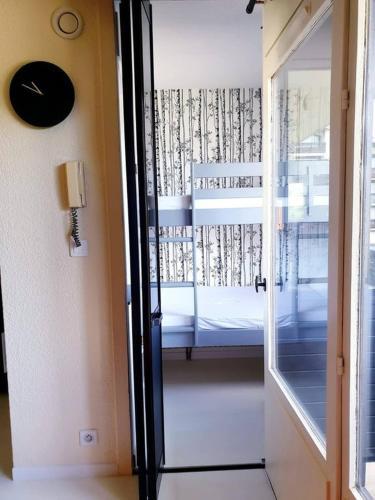 - une porte menant à une chambre avec un lit et une fenêtre dans l'établissement Mazots - Séjour aux Carroz, aux Carroz d'Arâches