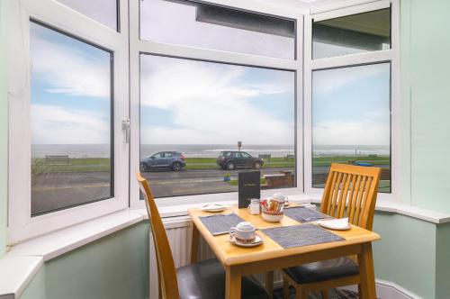 a dining room with a table and chairs and a window at The Wheeldale in Whitby