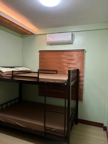 a room with two bunk beds and a desk at Heritage Haven Guesthouse in Vigan
