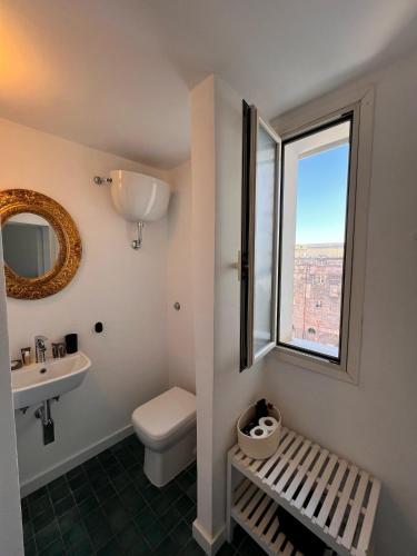 a bathroom with a toilet and a sink and a window at Bellini View in Naples