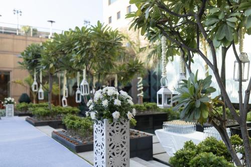 a garden with trees and flowers in a building at Crowne Plaza Today Gurugram by IHG in Gurgaon