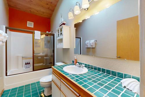 a bathroom with a sink and a toilet and a mirror at Whispering Wave in Gualala