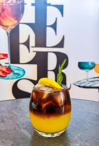 a drink on a table with a lemon on top at Yours Hotel Lifestyle in Chiclayo
