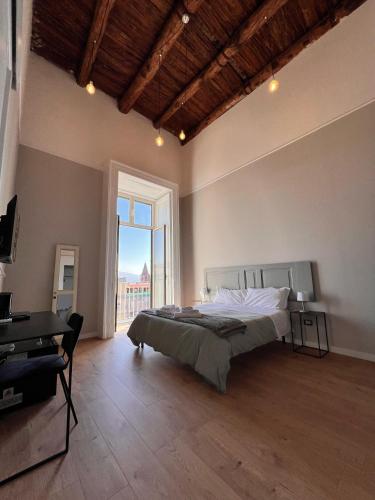 a bedroom with a bed and a large window at Bellini View in Naples