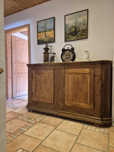a large wooden cabinet in a room with a door at Toskanahaus, NJUALMS in Tannheim