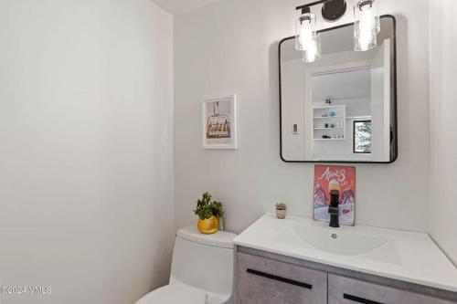 a bathroom with a toilet and a sink and a mirror at 10min Beaver Creek And 15 min Vail in Avon