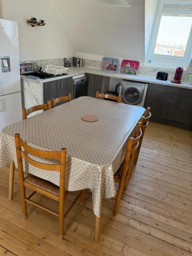 a kitchen with a table and chairs in a kitchen at F2 vu sur l Allier pour 4 pers in Moulins