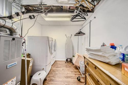 a room with a kitchen with a refrigerator and a counter at Pet Friendly Townhome WIth A Fireplace And A King Bed In Littleton in Littleton