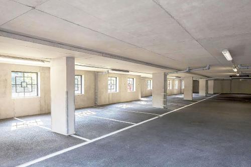 an empty parking lot in an empty building at Travaal.©om - 2 Bed Serviced Apartment Farnborough in Farnborough