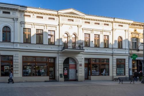 a large white building on a city street at MYE Apartments - Piotrkowska 44 in Łódź