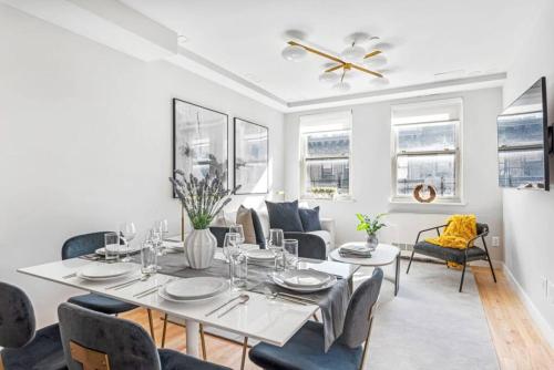 a dining room with a table and chairs at 3BR Penthouse Suite with Massive Private Rooftop in New York